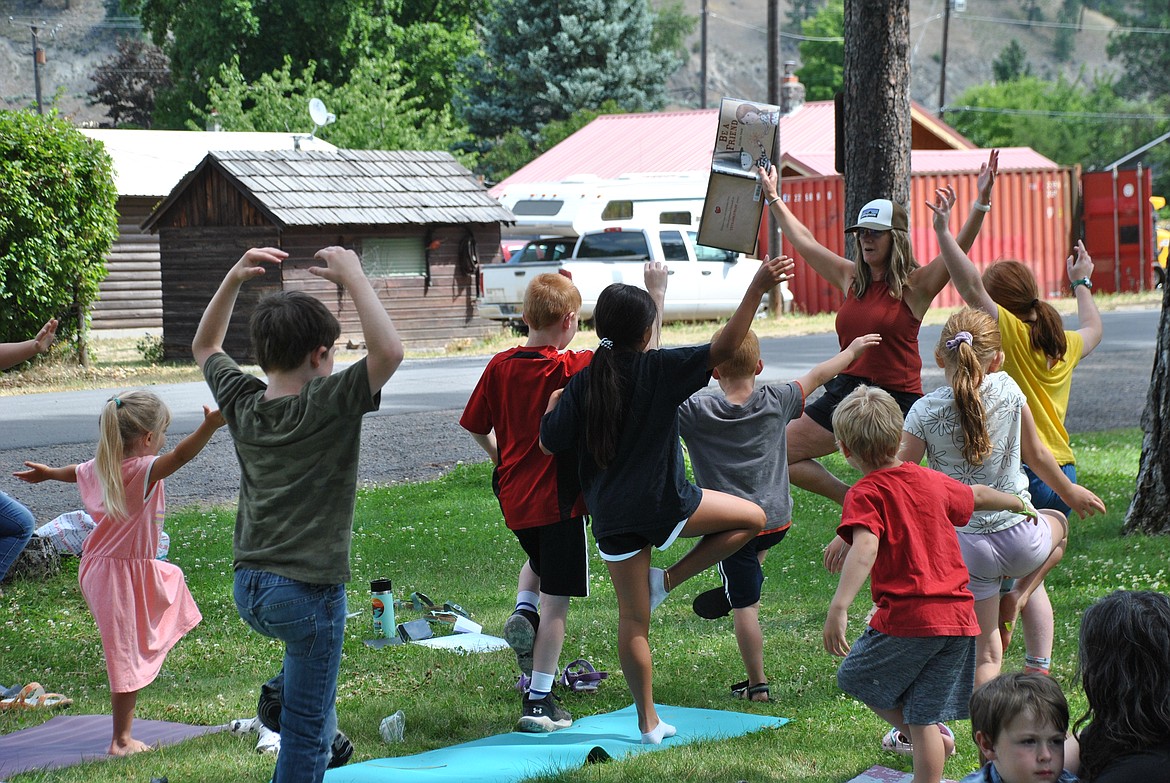 Terri Barclay, a former St. Regis Elementary Teacher, Office of Public Instruction Project Director, and instructor at the Montana Yoga Movement led an exciting and active story time session at Eva Horning Park on Tuesday, July 25. The Mineral County Library's Reading in the Park program concluded last week with a session of yoga for kids and beginners. Barclay read through the book, Be a Friend, as she and the children did a series of yoga poses like this tree pose. After the book and a bit of exercise, everyone celebrated with popsicles. (Mineral Independent/Amy Quinlivan)