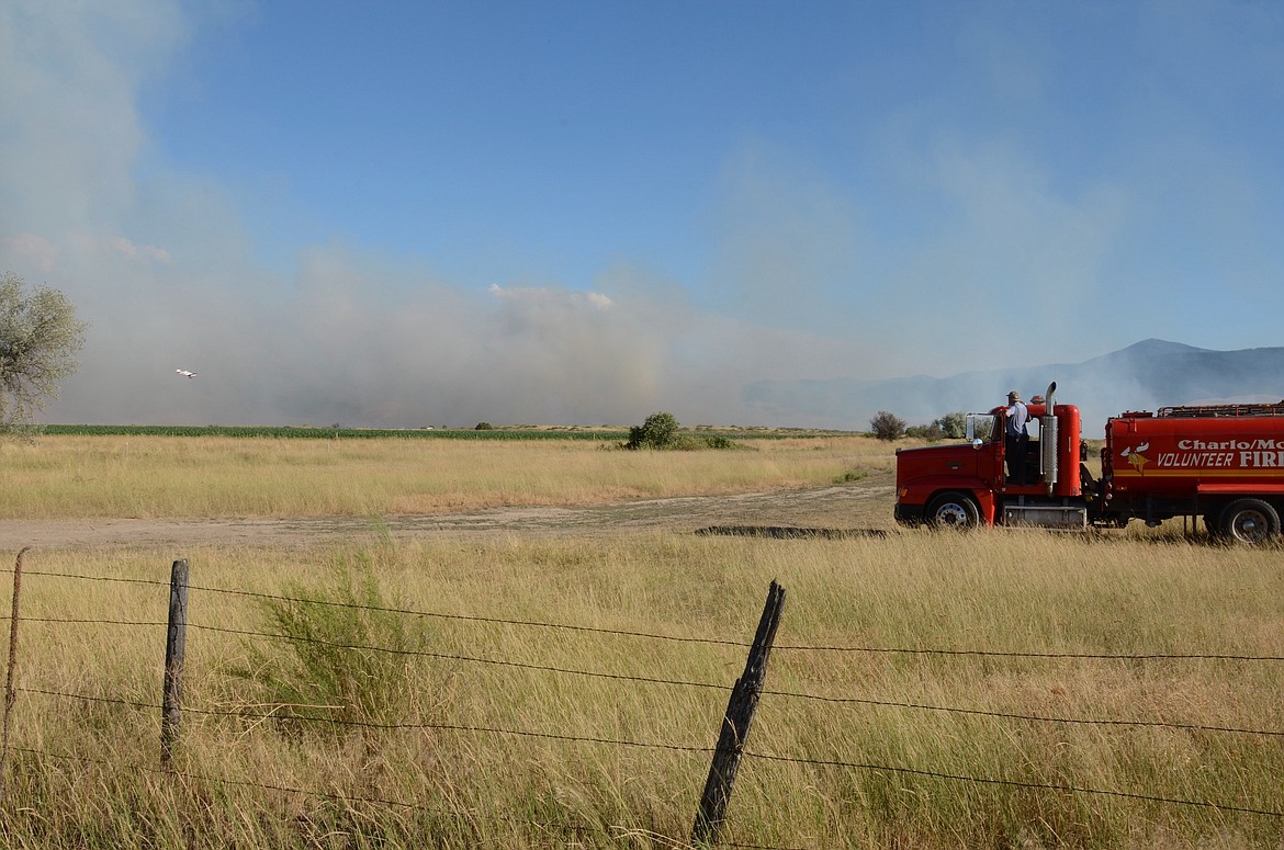 Keith Blevins of the Charlo-Moiese Fire Department keeps an eye on the Communication Butte fire north of Dixon as it threatened the east side of the Flathead River and the Bison Range Sunday afternoon. (Kristi Niemeyer/Leader)