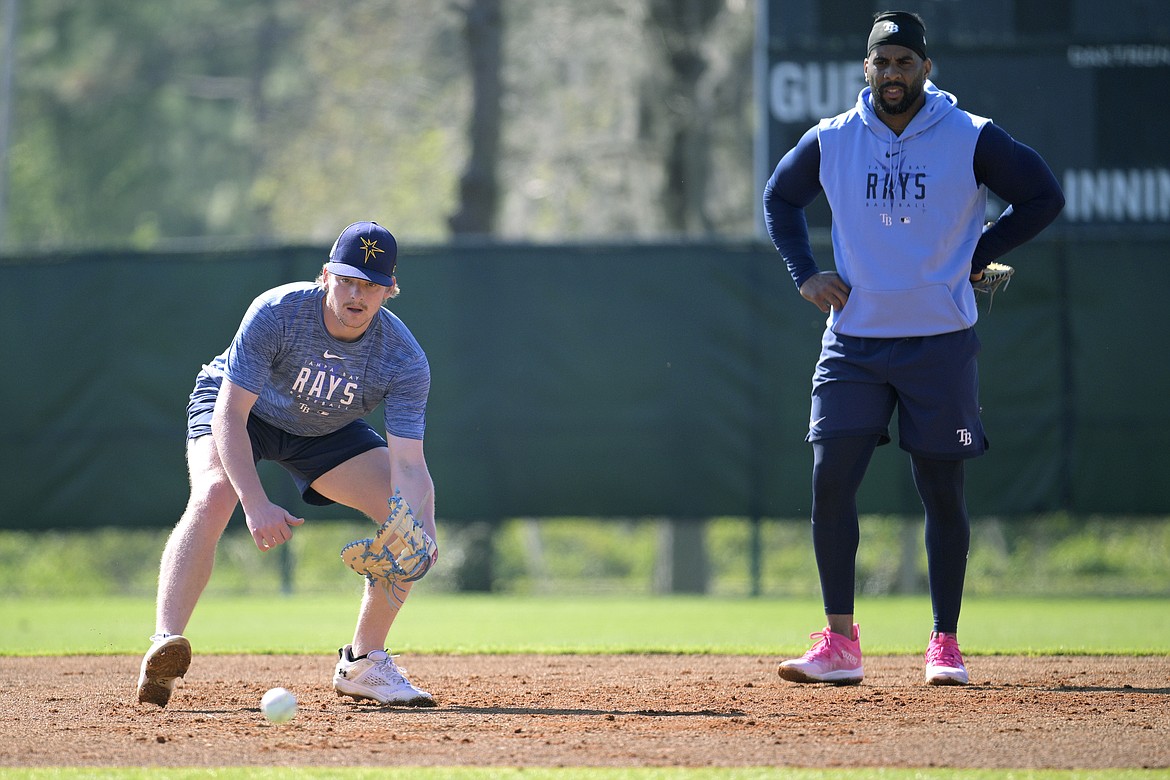 PHELAN M. EBENHACK/Associated Press
First baseman Kyle Manzardo and Yandy Diaz field ground balls during a Tampa Bay Rays practice in Kissimmee, Fla., in February. Manzardo, the Lake City High and Washington State product, was traded from the Tampa Bay organization to Cleveland on Monday.