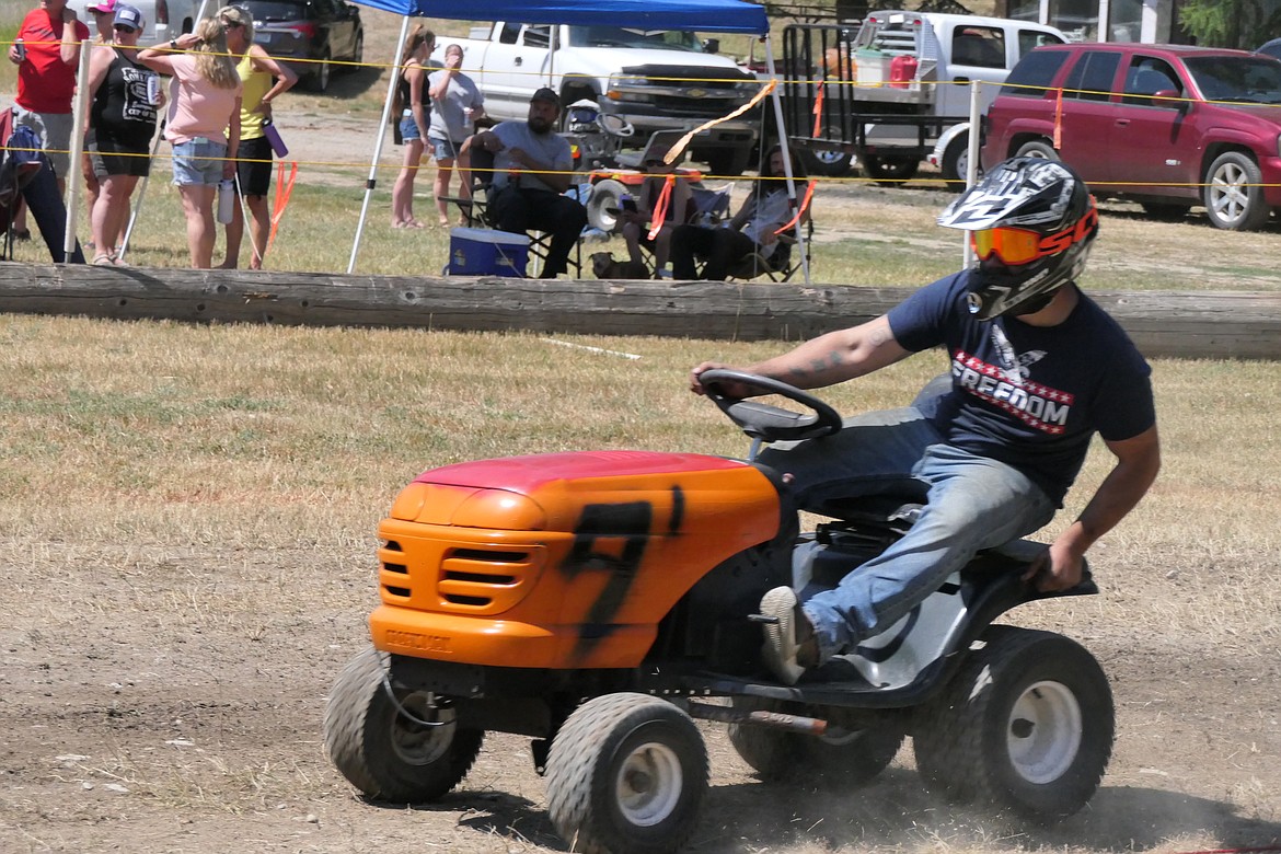 A lawn mower race leans into the far turn during this year's Wild Coyote Days lawn mower race Saturday. (Chuck Bandel/VP-MI)