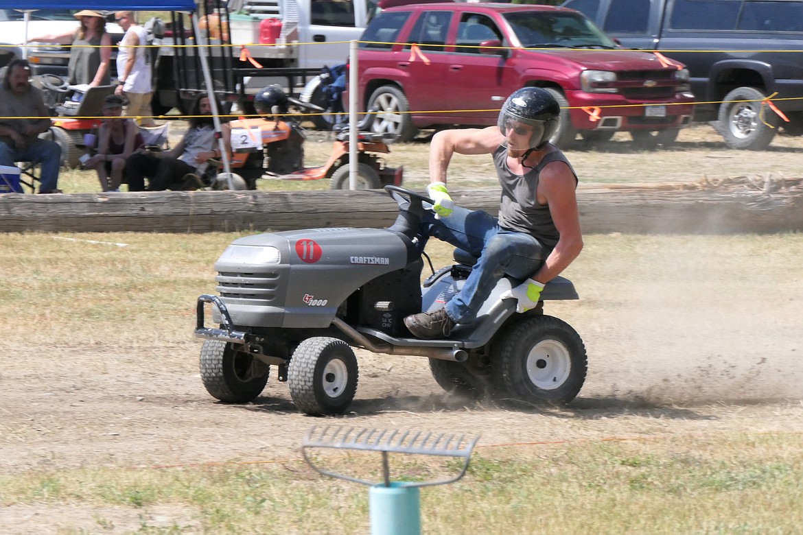 Last year's champion Corey Frank cuts a close corner during time trials of this year's Wild Coyote riding Lawn Mower races this past Saturday.  (Chuck Bandel/VP-MI)