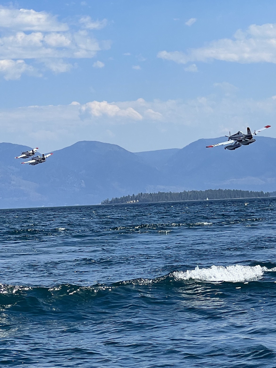 Three Single Engine Air Tankers (SEATs) skimmed Flathead Lake, before dousing the fire near Niarada Sunday afternoon. The blaze had consumed 4,275 acres by Monday and forced a temporary closure of Hwy. 28 between Elmo and Niarada. (Taurie Matt/Leader)