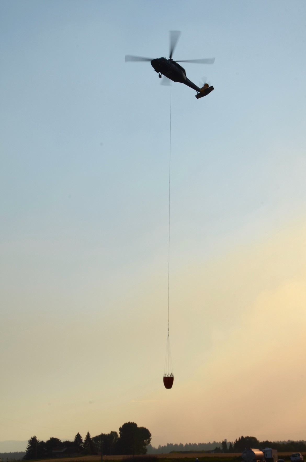 Like a giant bird, a Type 2 helicopter prepares to settle at the Ronan Airport after a long day of battling the blazes that flared up across the Mission Valley. (Kristi Niemeyer/Leader)