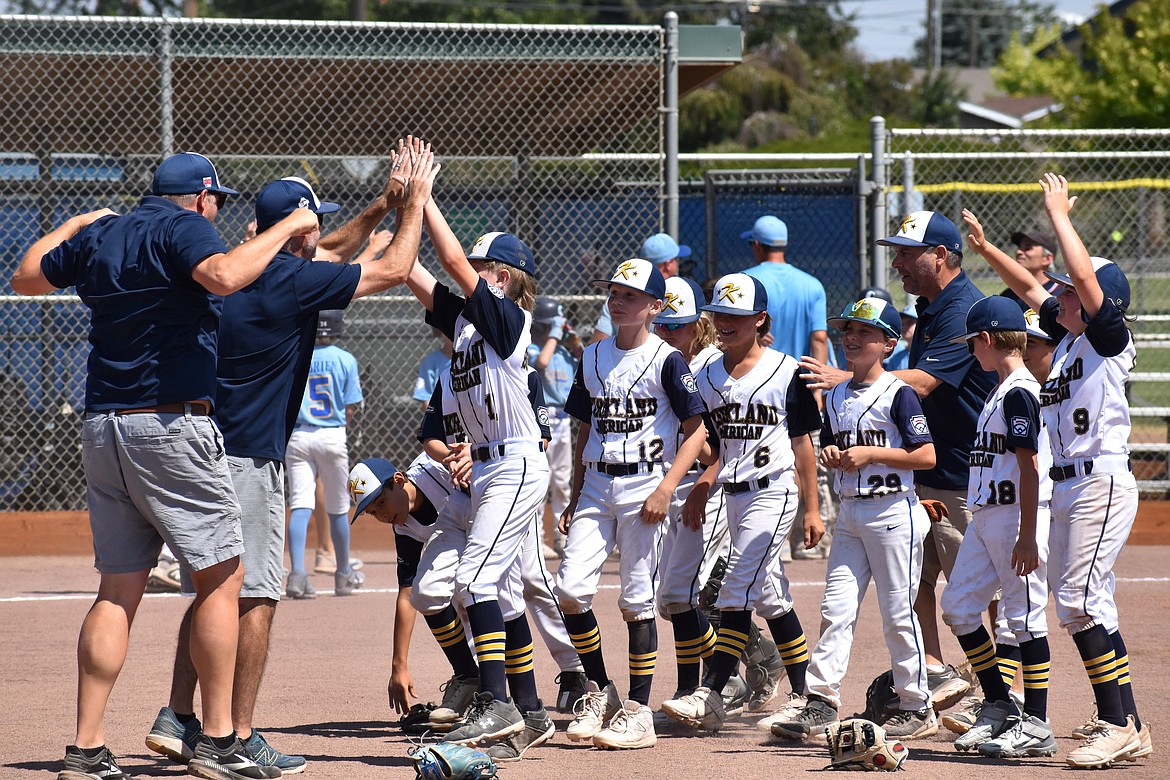 Kirkland American players and coaches celebrate after winning Saturday’s championship game 7-3 over Magnolia.