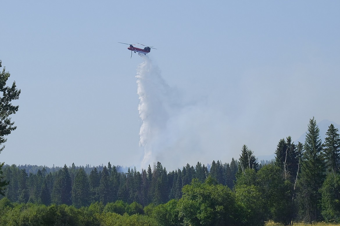 A type 1 firefighting helicopter drops water Monday on the North Lake Fire, a wildfire burning on the north end of Whitefish Lake. (Joseph Raudabaugh photo)