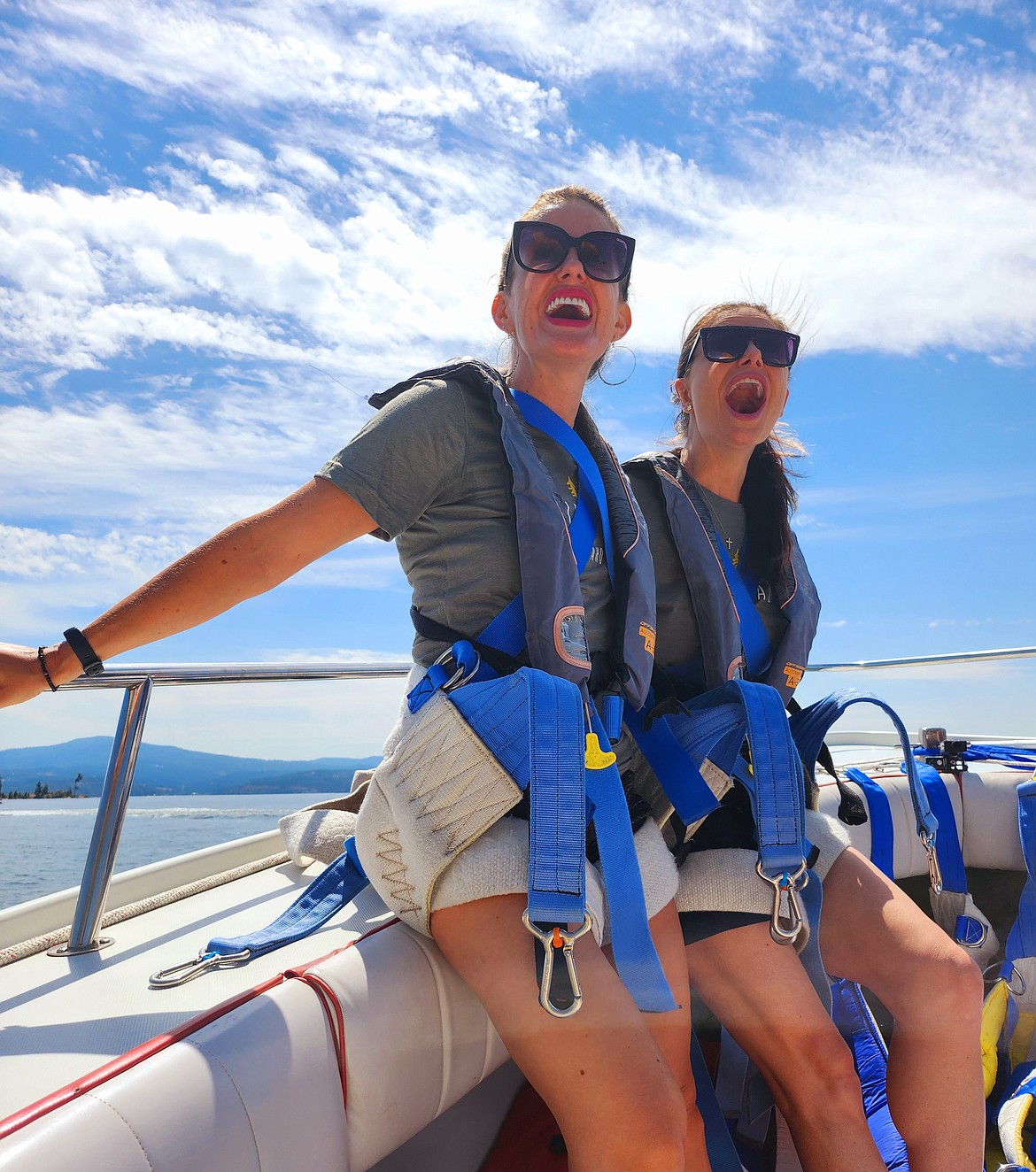 Sarah Polk and Nicole Bigham react to seeing the parasail unfurl before their first-ever ride.