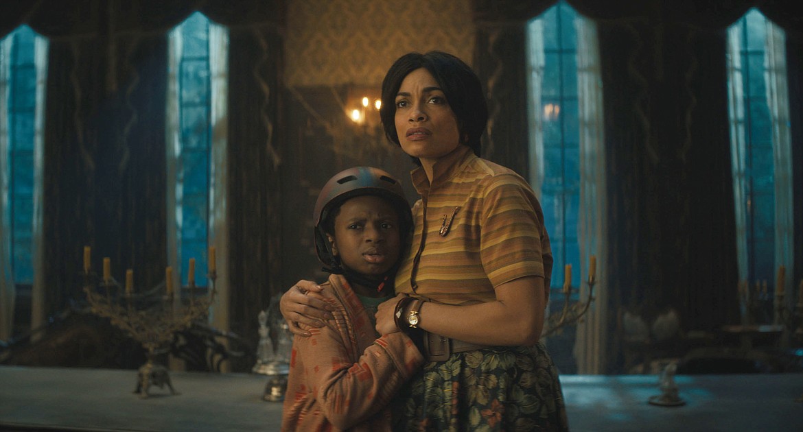 This image released by Disney Enterprises shows Chase Dillon and Rosario Dawson in a scene from "Haunted Mansion."