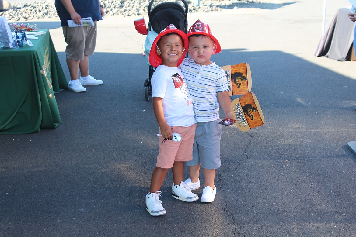 Gael Lopez, left, and Adrian Sanchez, right, both 3, happily wear their fire hats at National Night Out.