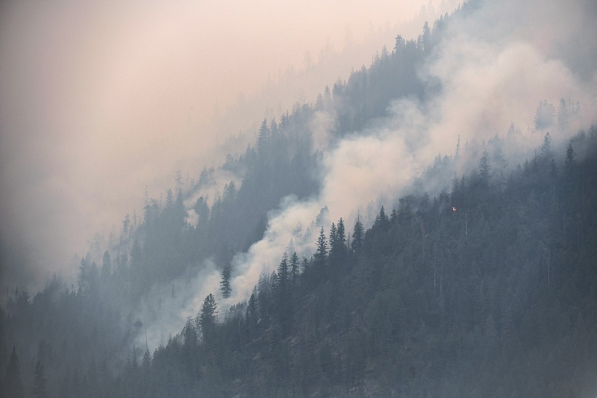 Smoke billows as the Niarada Fire burns on a mountainside south of HIghway 28 on Wednesday, Aug. 2. (Casey Kreider/Daily Inter Lake)