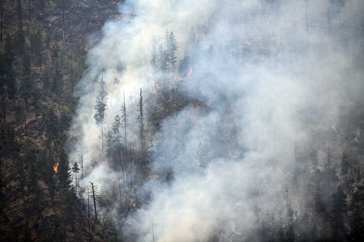 Smoke billows as the Niarada Fire burns on a mountainside south of HIghway 28 on Wednesday, Aug. 2. (Casey Kreider/Daily Inter Lake)