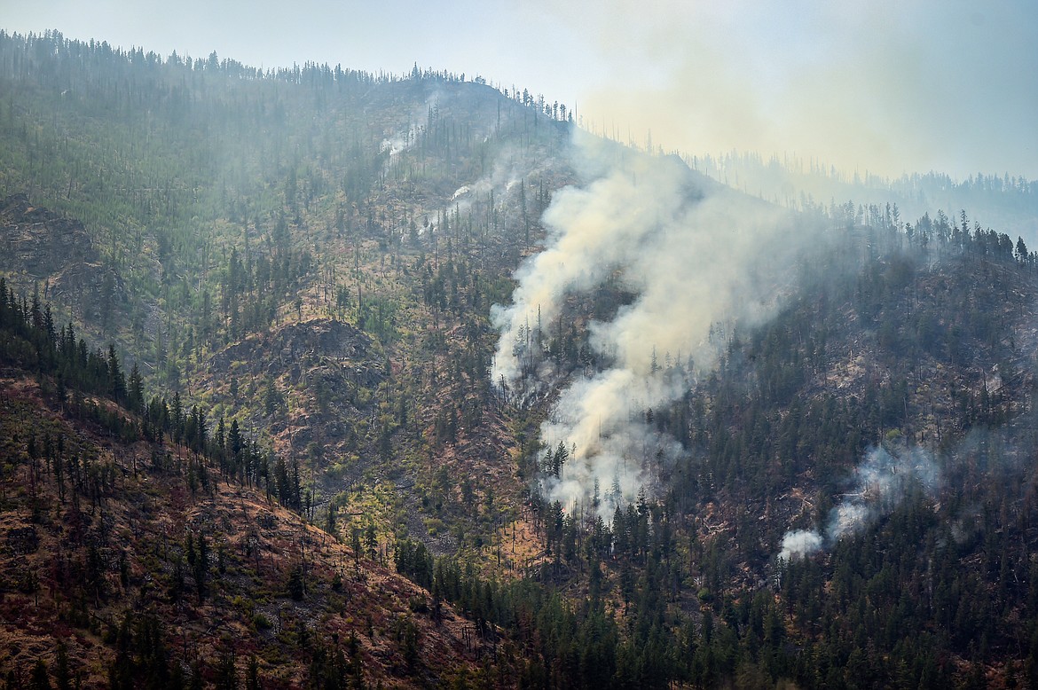 Smoke billows as the Niarada Fire burns on a mountainside south of HIghway 28 on Wednesday, Aug. 2. (Casey Kreider/Daily Inter Lake)