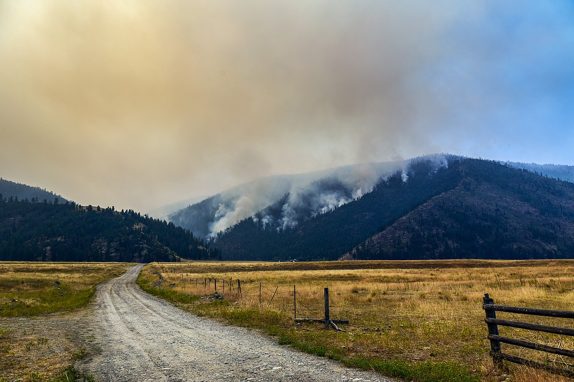 Smoke billows as the Niarada Fire burns on a mountainside south of HIghway 28 on Wednesday, Aug. 2. (Casey Kreider/Daily Inter Lake)