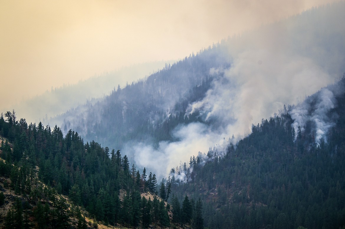 Smoke billows as the Niarada Fire burns on a mountainside south of HIghway 28 on Wednesday, Aug. 2. (Casey Kreider/Daily Inter Lake)