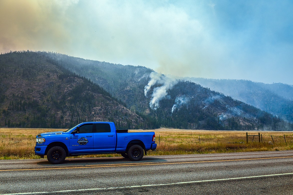 Smoke billows as the Niarada Fire burns on a mountainside south of HIghway 28 on Wednesday, Aug. 2. (Casey Kreider/Daily Inter Lake)