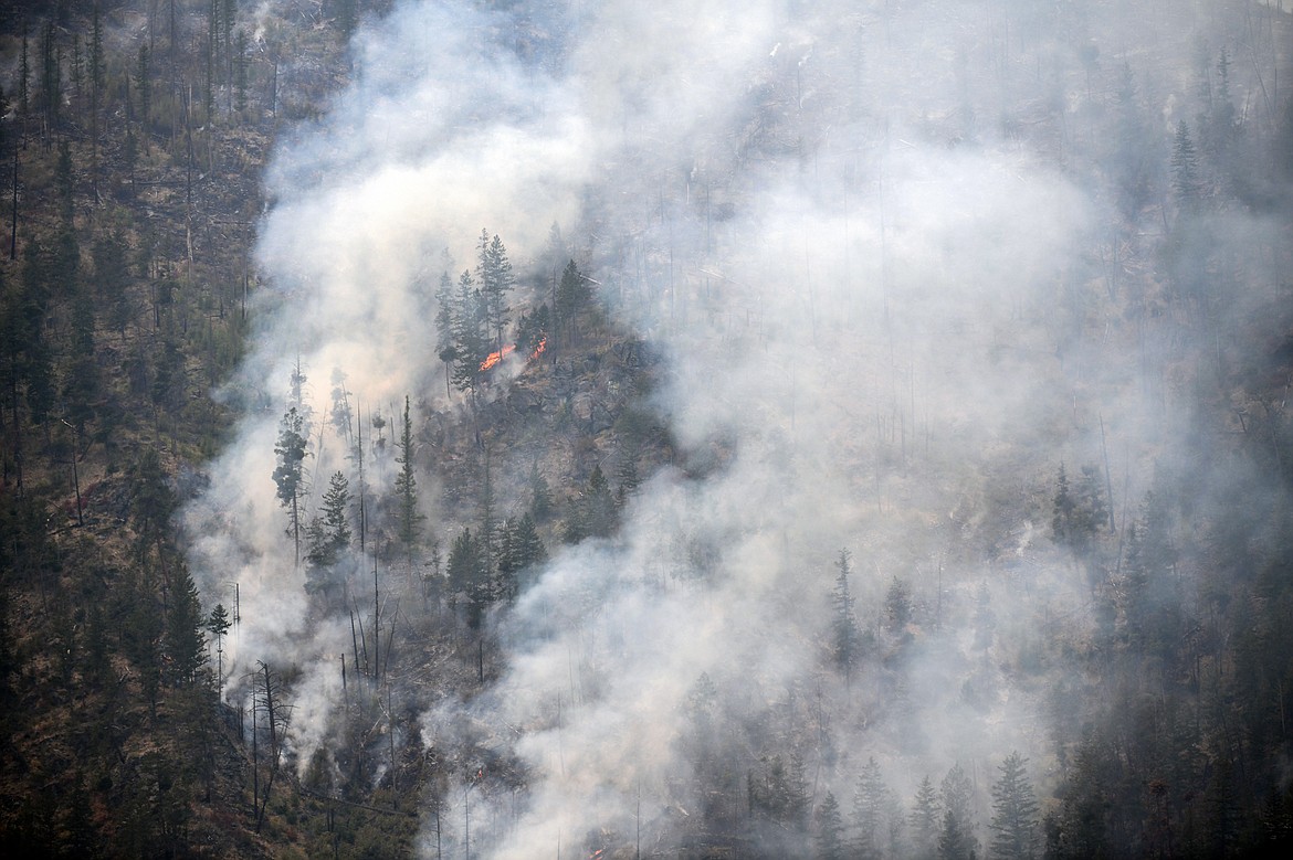 Smoke billows as the Niarada Fire burns on a mountainside south of HIghway 28 on Wednesday, Aug. 2. (Casey Kreider/Daily Inter Lake)