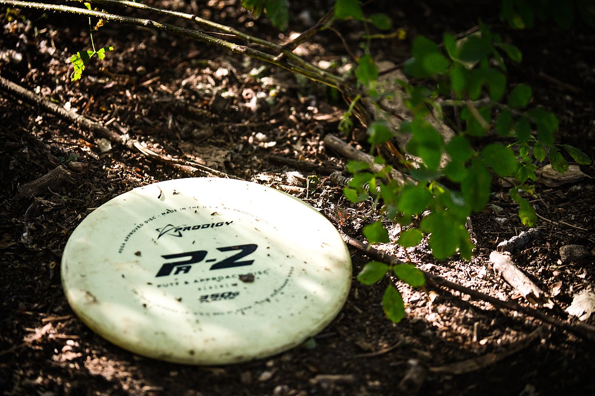 A Prodigy Disc PA-2 Putt and Approach Disc, for throws close to the basket, lies on the ground during a Flathead Valley Disc Golf round at Lawrence Park on Tuesday, Aug. 1. (Casey Kreider/Daily Inter Lake)