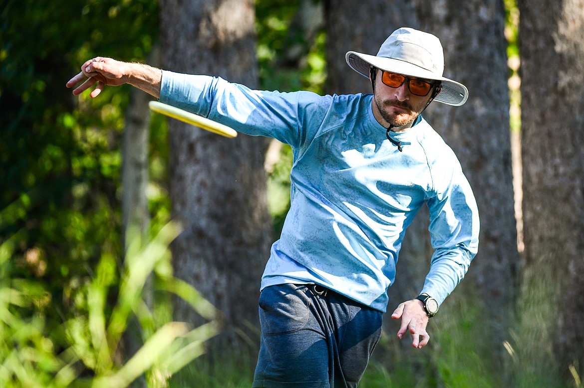 Max Dwyer throws his driver disc during a round a Flathead Valley Disc Golf round at Lawrence Park in Kalispell on Tuesday, Aug. 1. (Casey Kreider/Daily Inter Lake)