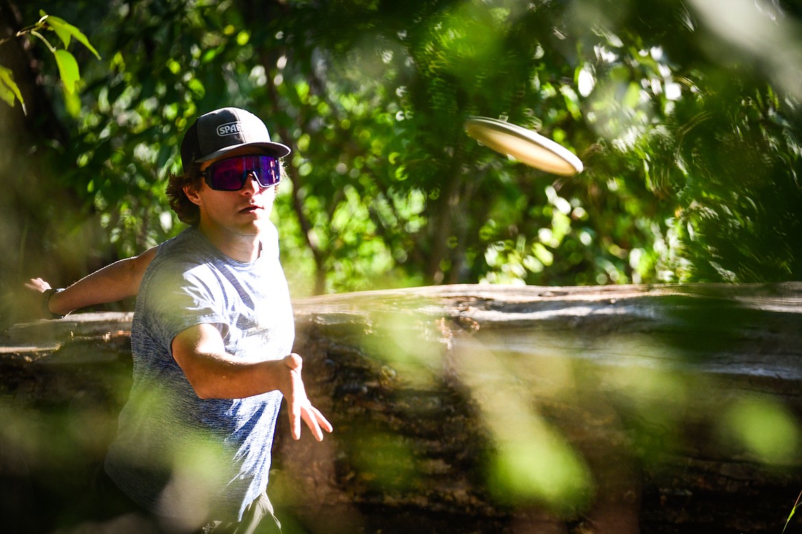 David Trussell, president of Flathead Valley Disc Golf, putts during a round at Lawrence Park in Kalispell on Tuesday, Aug. 1. (Casey Kreider/Daily Inter Lake)