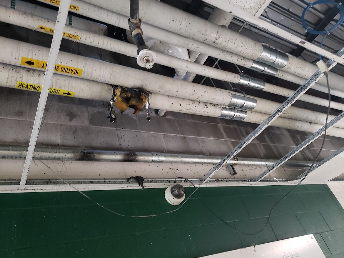 Damage caused by a fire that likely started from a mechanical equipment failure, above the sprinkler system in the Lakeland High School entry hallway.