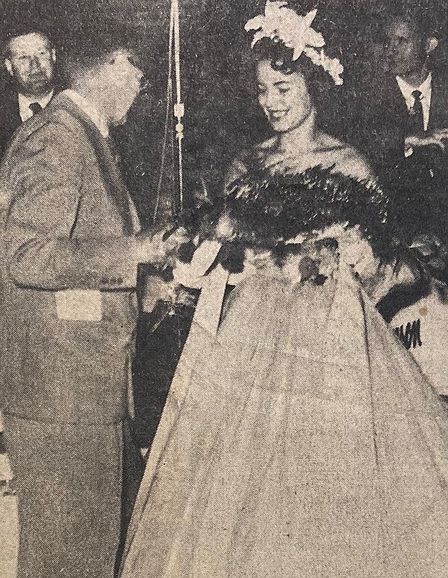 Mayor P.A. Christianson hands a bouquet to Miss Miracle Mile Eleanor Muller.