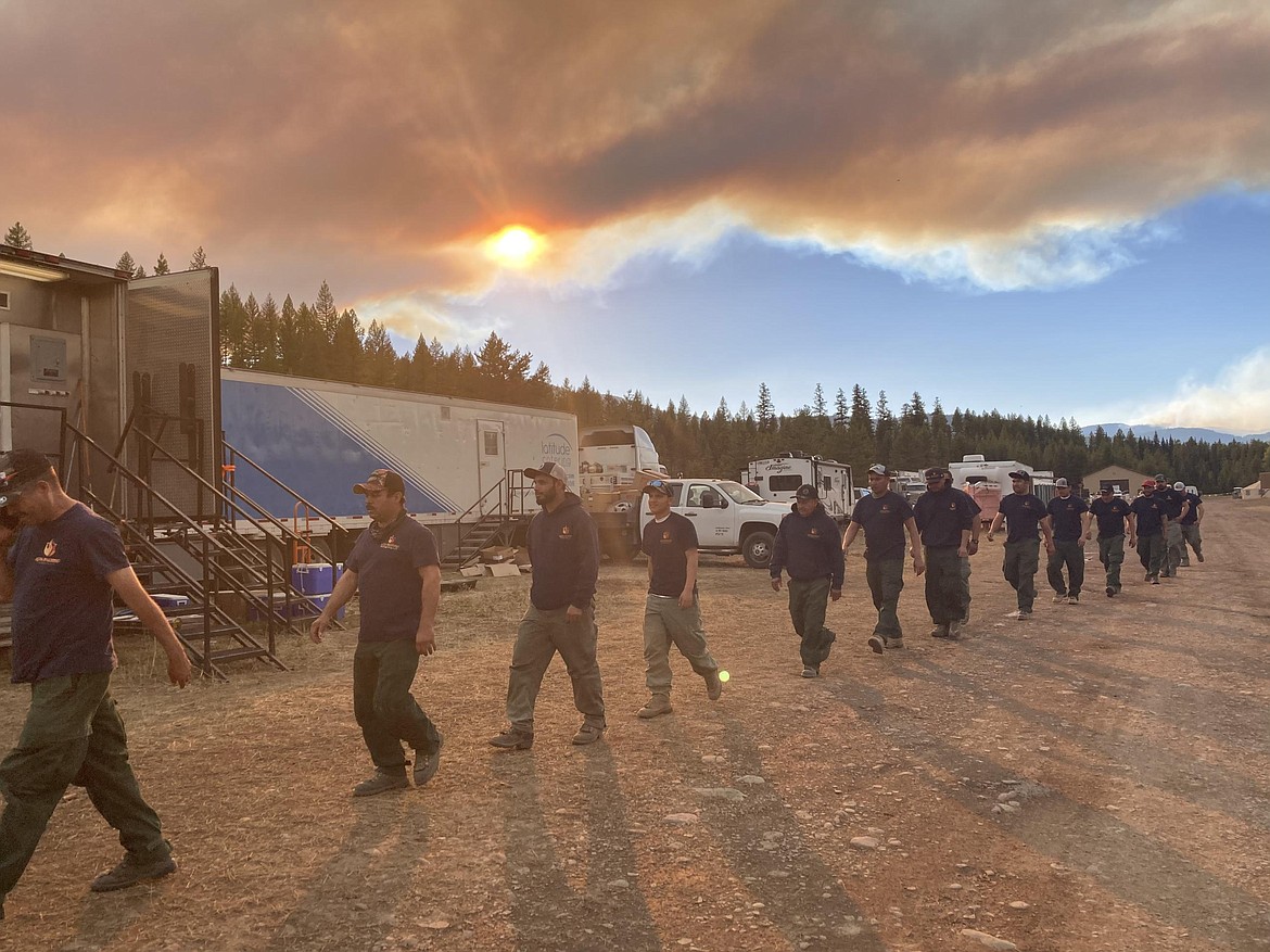 Wildfire crews walks to dinner at the Colt Fire base camp north of Seeley Lake on July 31, 2023. (InciWeb photo)