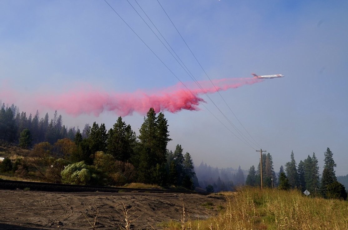 A plane drops retardant on the West Hallett fire near Spokane.