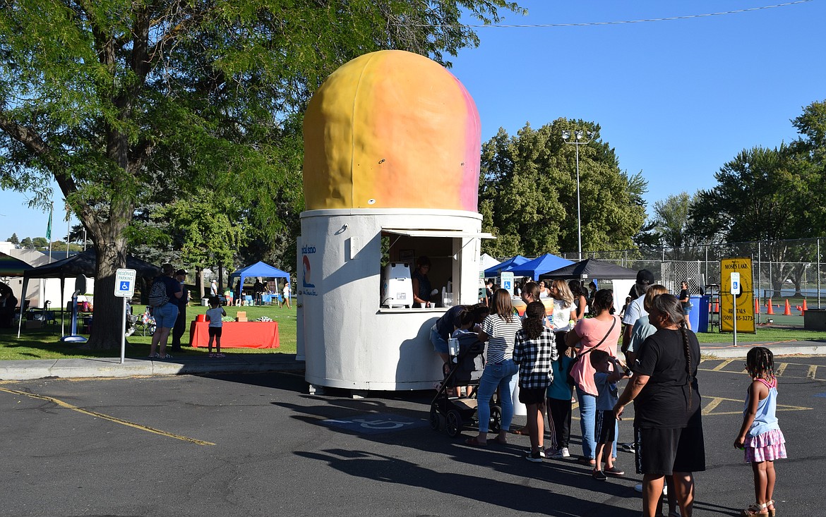 The snow cone line at National Night Out in Moses Lake Tuesday was one of the longest at the beginning of the event in the evening heat. Snow cones and other food were provided for free at the event.