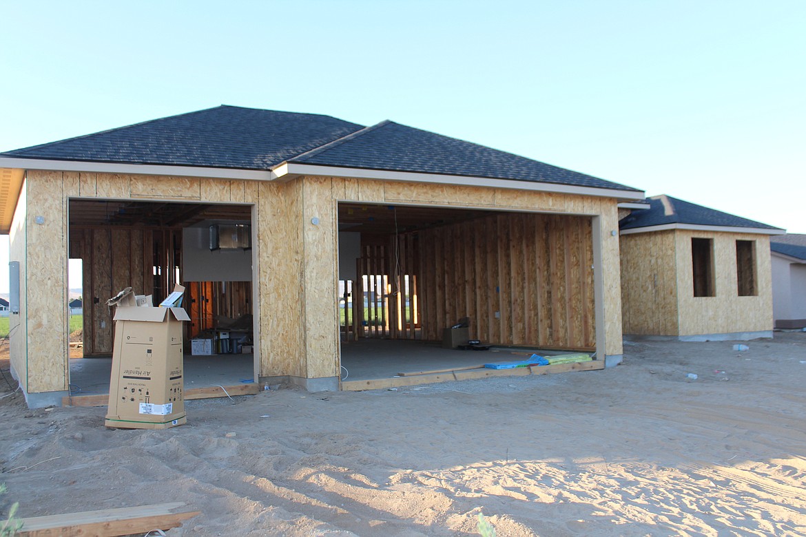 The walls go up on a new house in the southwest quadrant of Quincy. Real estate professionals said the price points in Quincy are higher for homes than in other parts of Grant County.