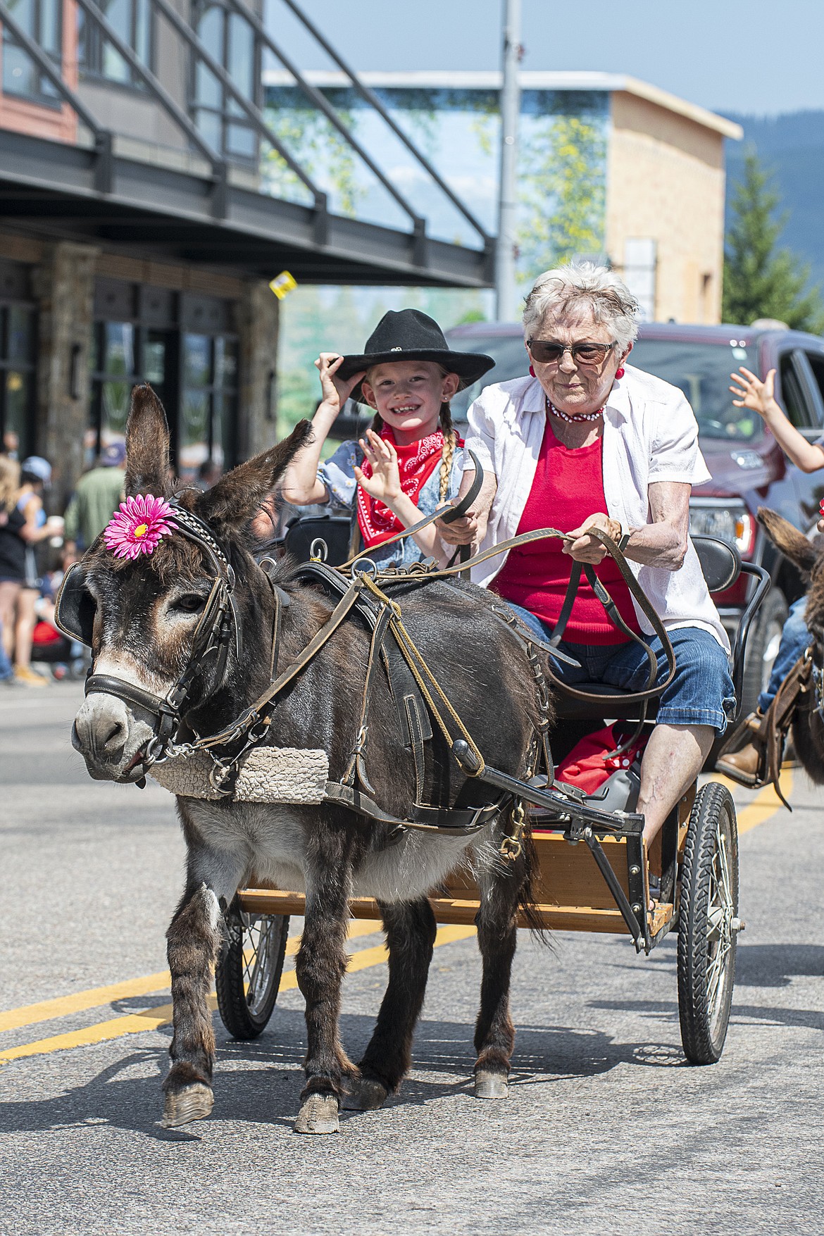 Judy Johnson (right) takes off down Nucleus Avenue on her miniature donkey cart during the parade.