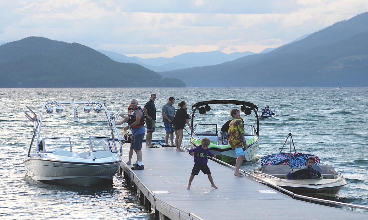 People stand on the dock at City Beach on Whitefish Lake in this file photo. (Daily Inter Lake FILE)