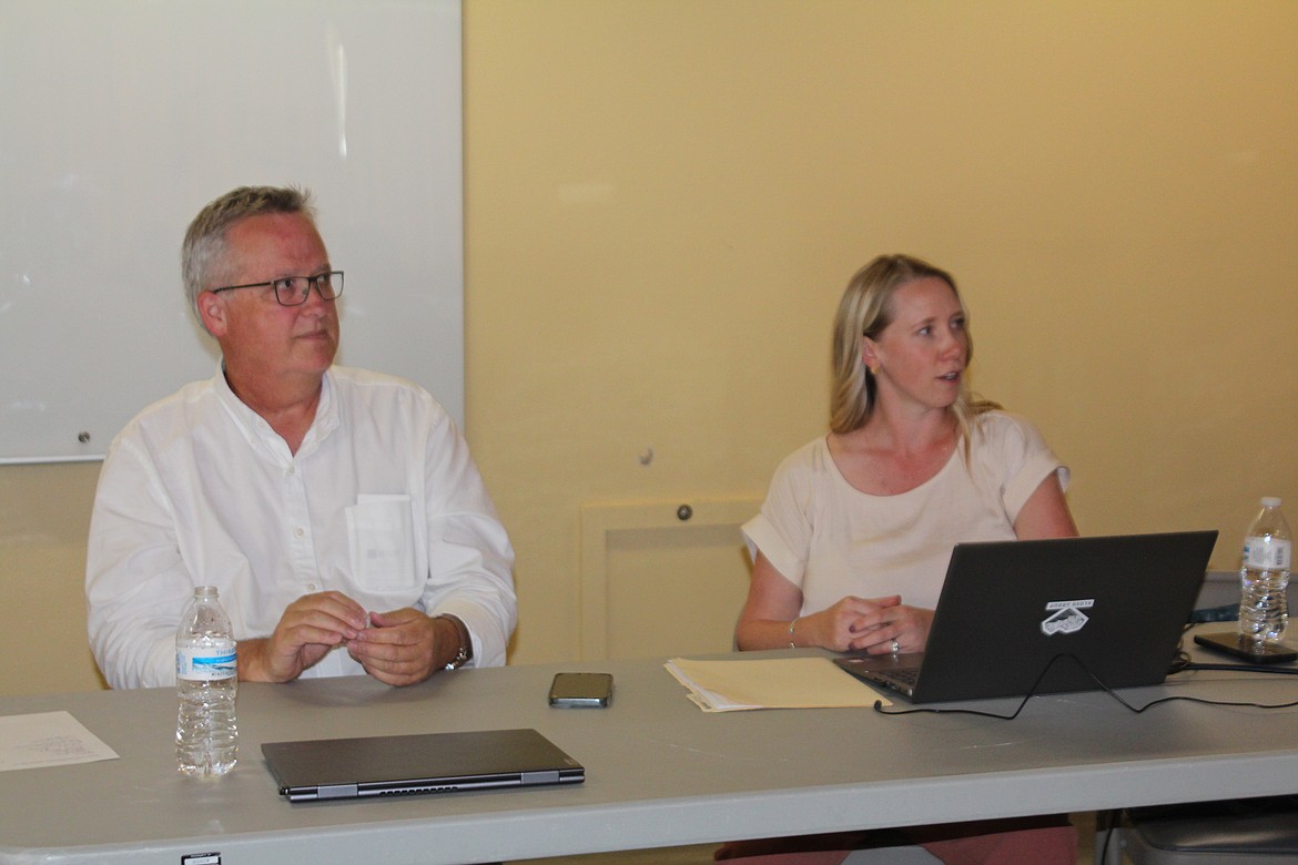 Kayla Van Lieshout, right, and Joe Kunkel, left, explain the details of authorization for the Quincy Valley Medical Center project during a hospital board meeting Wednesday.