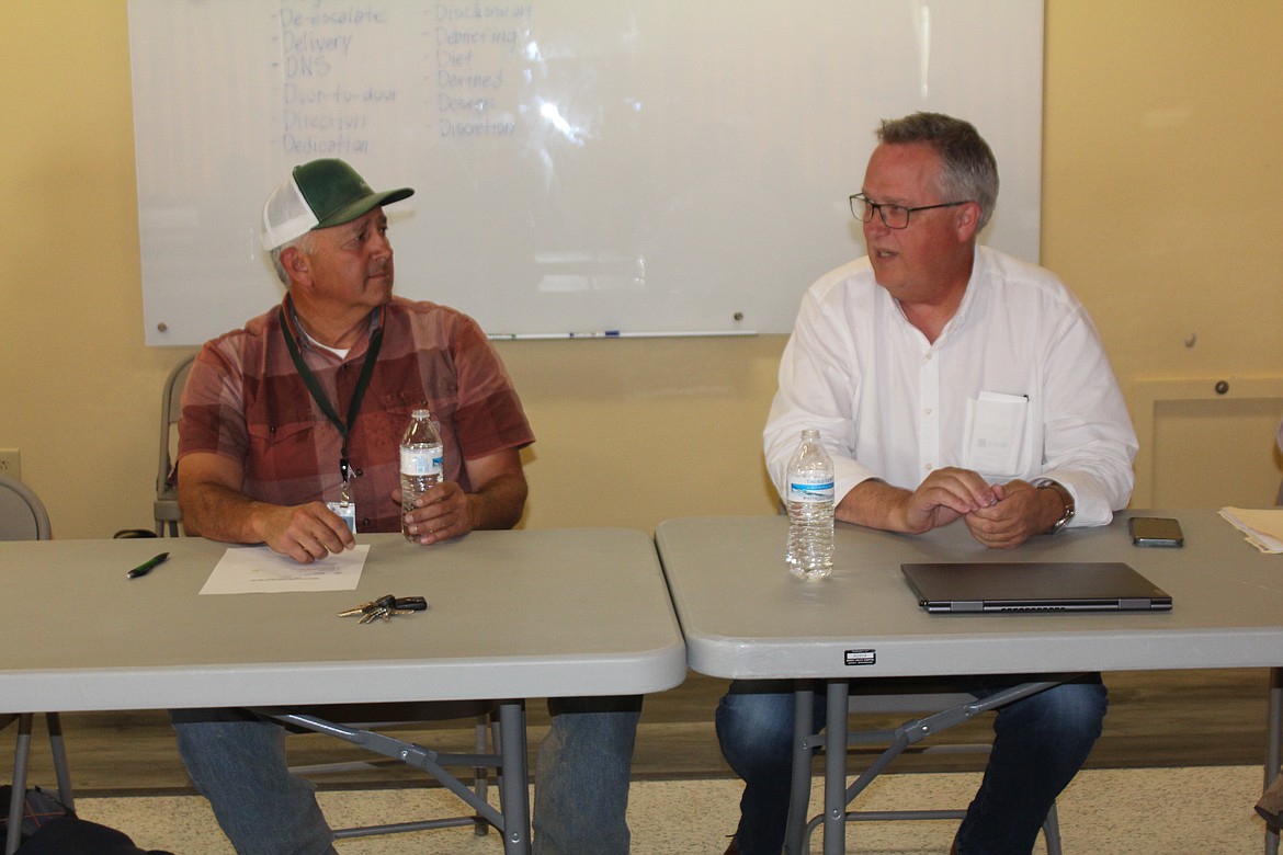 Joe Kunkel, right, discusses the next phase of the Quincy Valley Medical Center construction with the hospital board, including commissioner Anthony Gonzales, left, Wednesday.