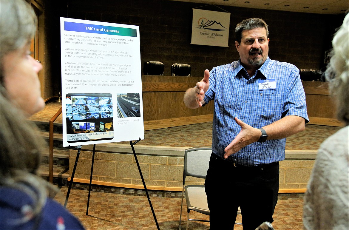 Ryan Hawkins with the Idaho Transportation Department speaks with visitors about traffic management centers during an open house in the Coeur d'Alene Public Library Community Room on Thursday.