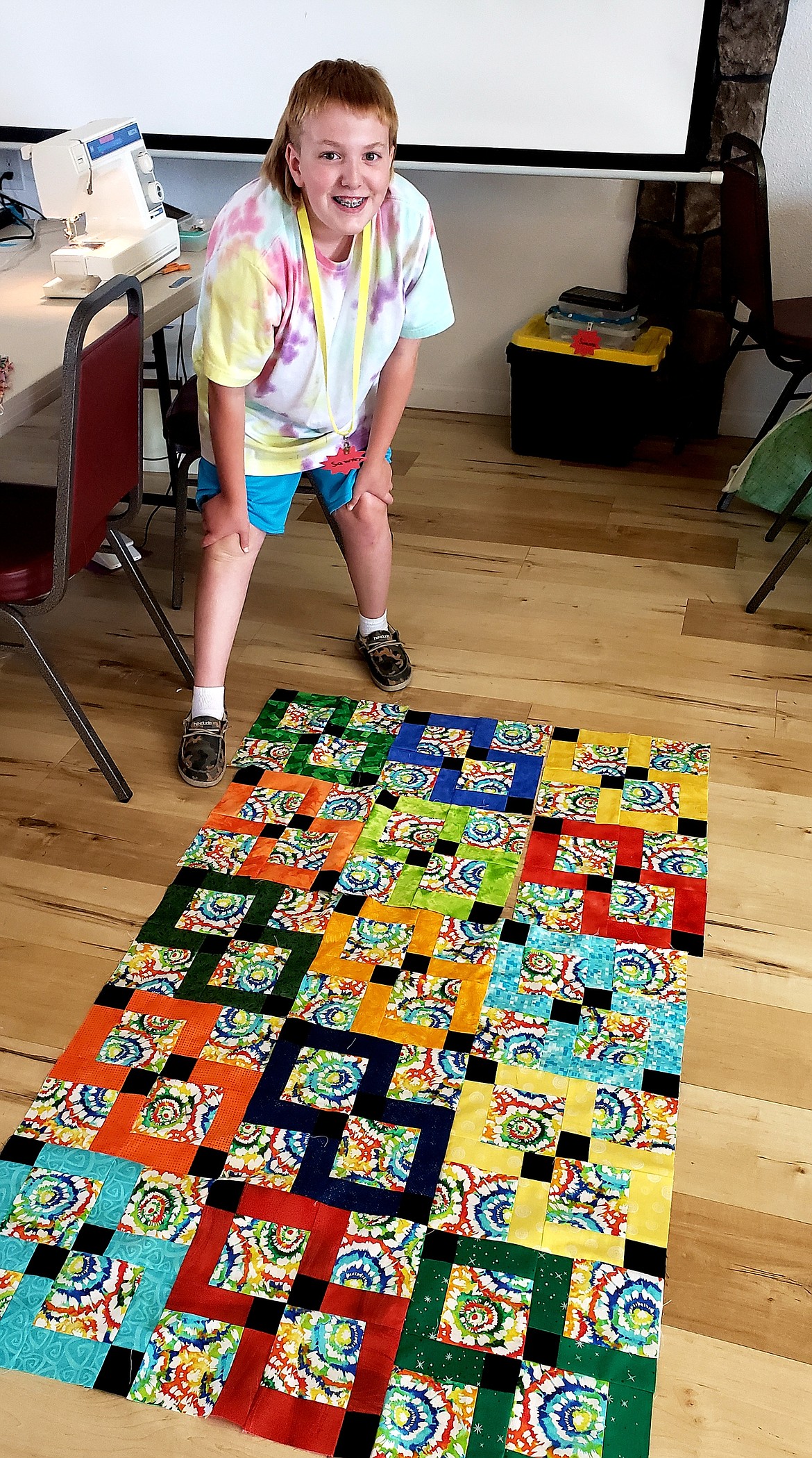 Sawyer Combs, 12, arranges the blocks for his quilt at Quilt Camp. He loves color, the brighter the better.