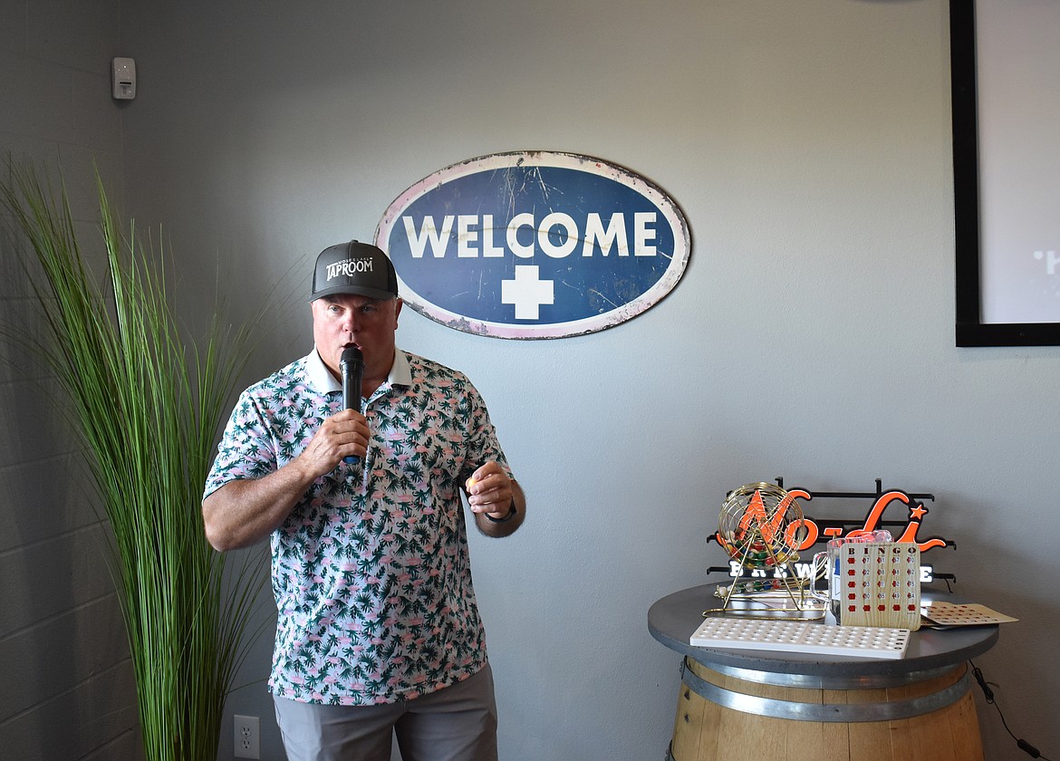 Grant County Sheriff Joe Kriete reads the number on a bingo ball Thursday at the Moses Lake taproom. Proceeds from the bingo night went to the Columbia Basin Cancer Foundation.