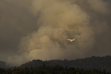 An air tanker drops retardant Thursday on the fire near Hayden Lake.