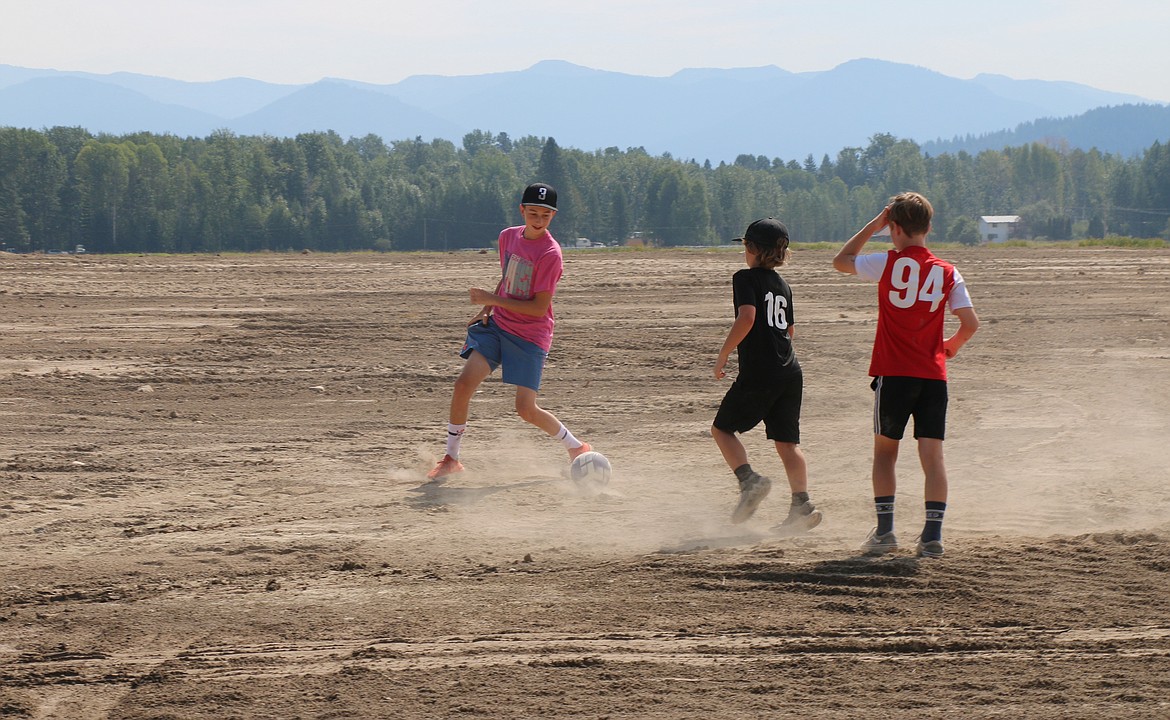 Area youth took advantage of a soccer ball at Friday's groundbreaking for the Field of Dreams to play a pickup game of soccer.