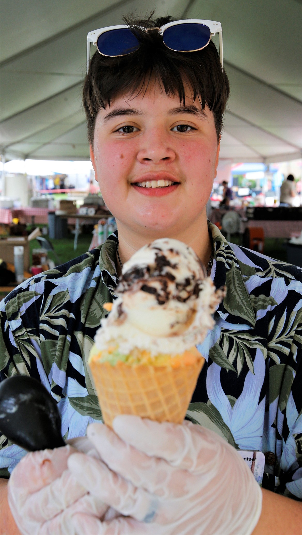 Kevin McGruder holds up an ice cream cone he made for a customer on Friday at Art on the Green.