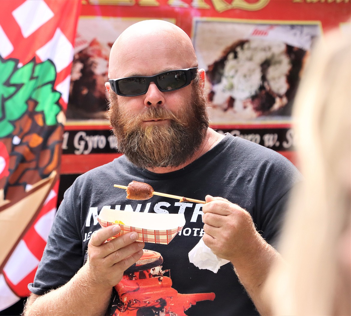 Buck Palmer tries a corn dog at Taste of Coeur d'Alene on Friday.