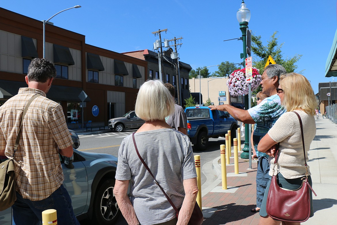 Chris Corpus, a Bonner County History Museum volunteer, talks about the city's history as he gives a history tour of downtown Sandpoint with Micheal Bigley, a member of the Lake Pend Oreille Repertory Theatre.