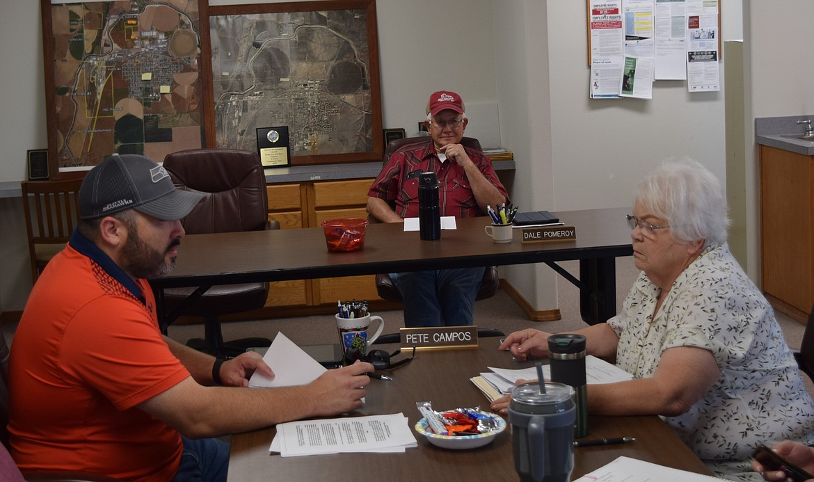 Port of Warden Commissioners Pete Campos, left, and Dale Pomeroy, middle, as well as the Port’s Executive Director Pat Millard, right, converse before convening Thursday’s meeting, which saw a progress report on the ongoing industrial bypass road project.