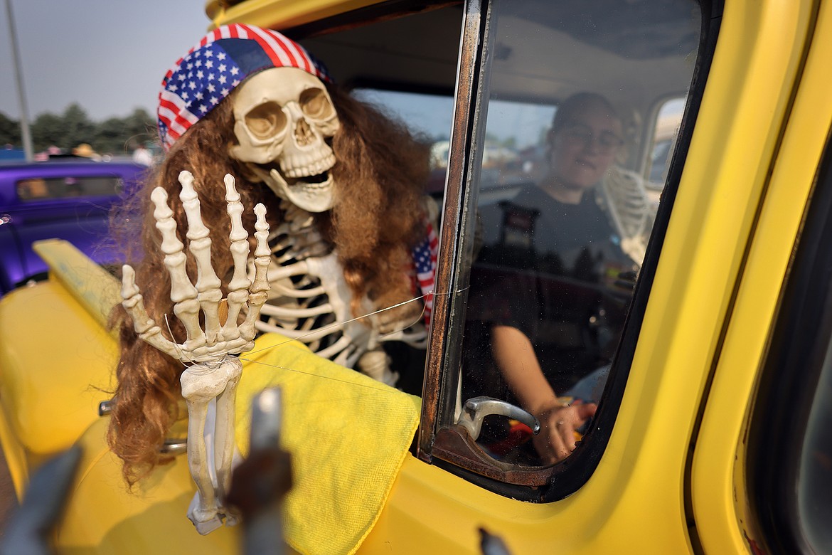 A patriotic passenger greets the crowd at the Evergreen Show 'N Shine car show at Conlin's Furniture on Saturday, Aug. 5. (Jeremy Weber/Daily Inter Lake)