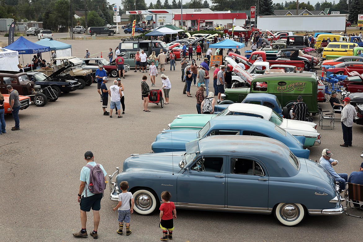 Attendees walk through rows of classic vehicles at the Evergreen Show 'N Shine car show at Conlin's Furniture on Saturday, Aug. 5. (Jeremy Weber/Daily Inter Lake)