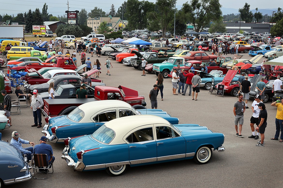 Attendees walk through rows of classic vehicles at the Evergreen Show 'N Shine car show at Conlin's Furniture on Saturday, Aug. 5. (Jeremy Weber/Daily Inter Lake)