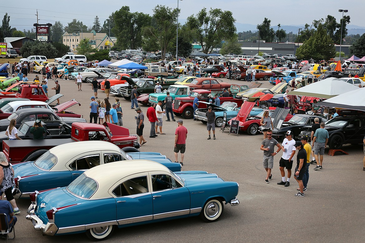 Attendees walk through rows of classic vehicles at the Evergreen Show 'N Shine car show at Conlin's Furniture on Saturday, Aug. 5. (Jeremy Weber/Daily Inter Lake)