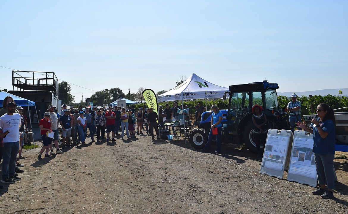Bernadita Sallato, right, a tree fruit extension specialist with the Washington State University Prosser Irrigated Agriculture Research and Extension Center, speaks with Smart Orchard Field Day event attendees regarding orchard nutrients and data collection technologies.