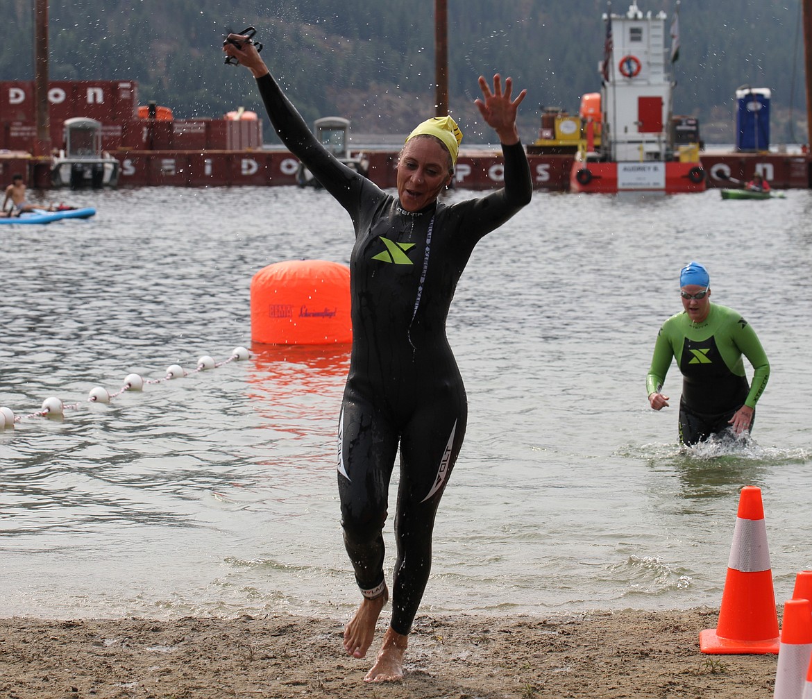 A woman celebrates as she reaches the finish line on Saturday.