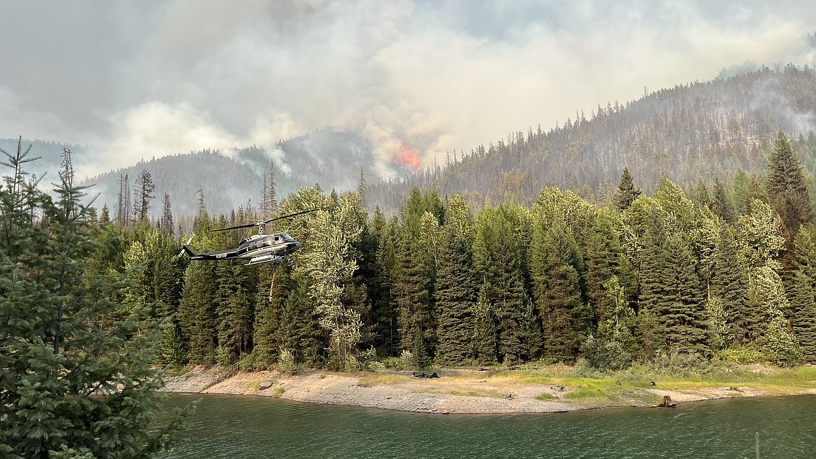 A helicopter loads up with water from the Hungry Horse Reservoir to aid in suppressing growth on the west side of Ridge Fire on Sunday, Aug. 6, 2023. (InciWeb photo)