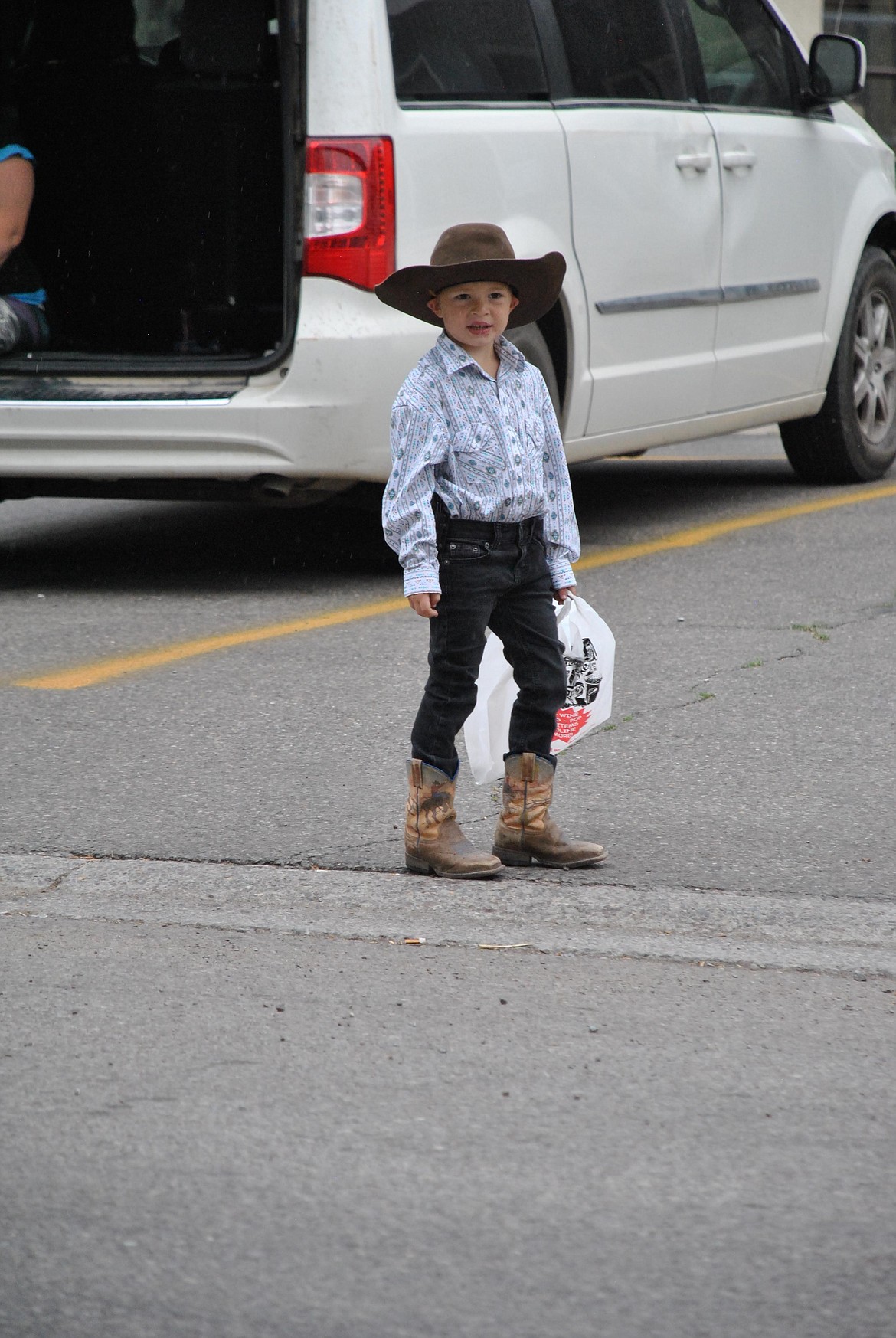 A little buckaroo waits alongside River Street for the parade to begin Saturday morning. (Mineral Independent/Amy Quinlivan)