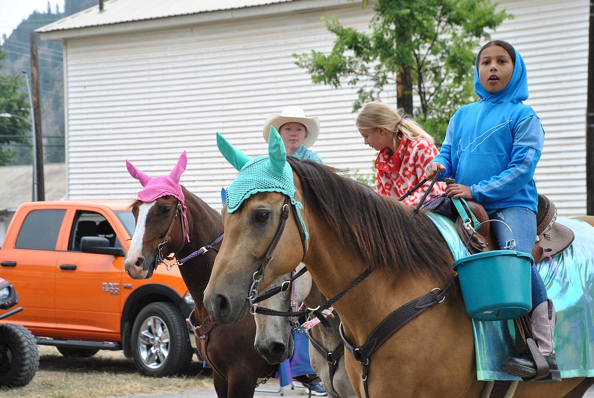 Brynley Conrow rides with a trio of decorated horses during the Mineral County Fair Parade. (Mineral Independent/Amy Quinlivan)